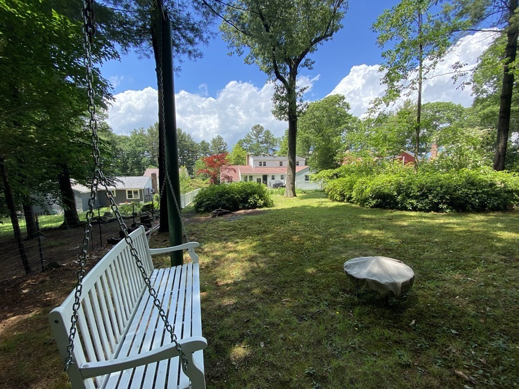 13 Pine Knoll Road Lexington, MA 02420 - Photo 23 of 24 a view of a table and chairs in backyard of the house
