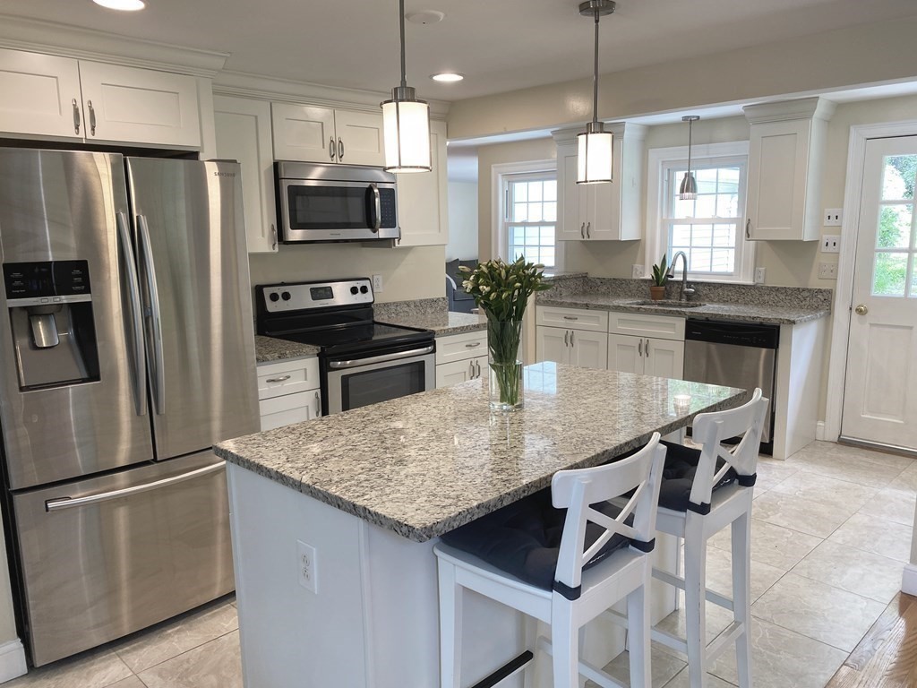 13 Pine Knoll Road Lexington, MA 02420 - Photo 6 of 24 a kitchen with stainless steel appliances granite countertop a kitchen island hardwood floor and a sink