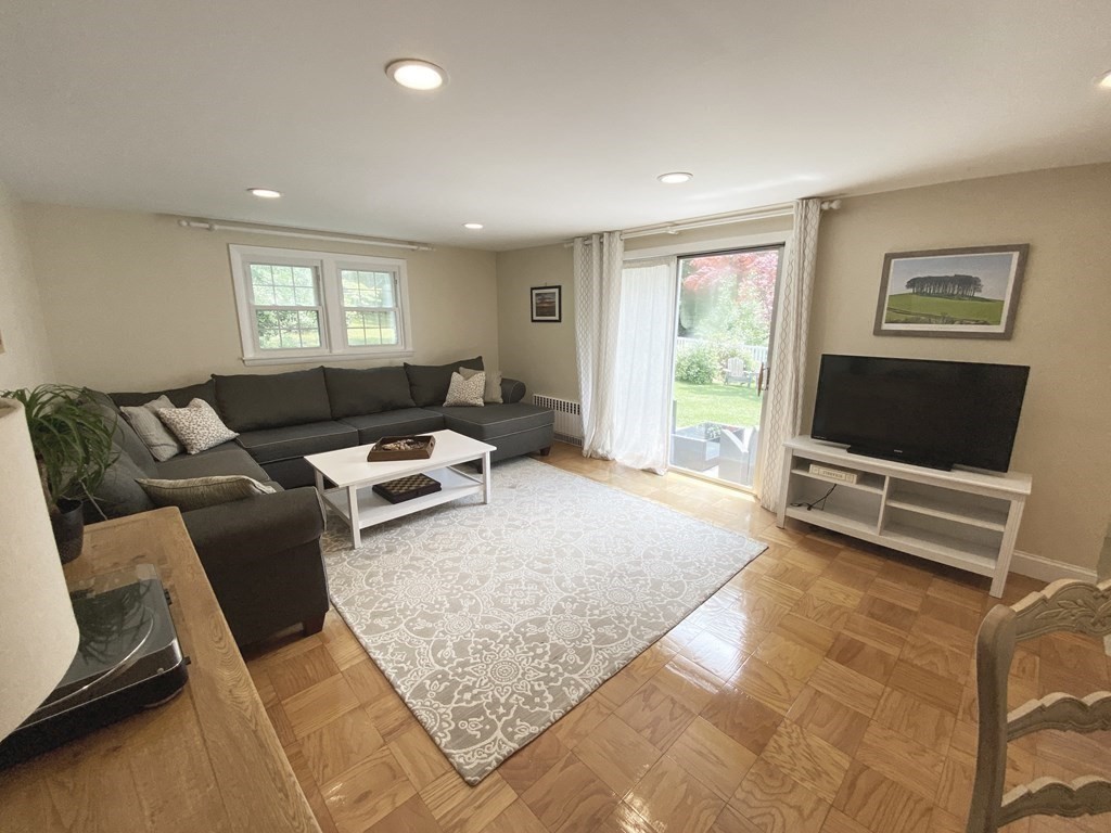 13 Pine Knoll Road Lexington, MA 02420 - Photo 7 of 24 a living room with furniture and a flat screen tv