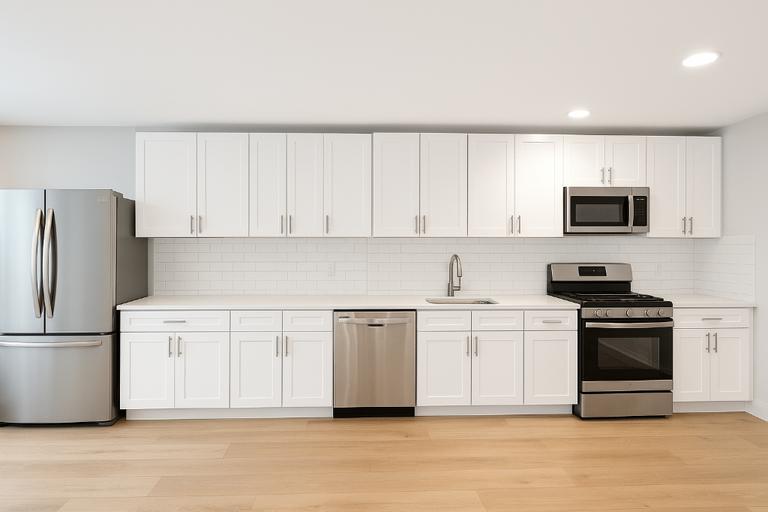 a kitchen with stainless steel appliances granite countertop a stove a sink and a refrigerator