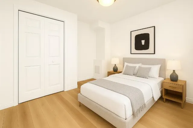 a bedroom with a bed and a potted plant