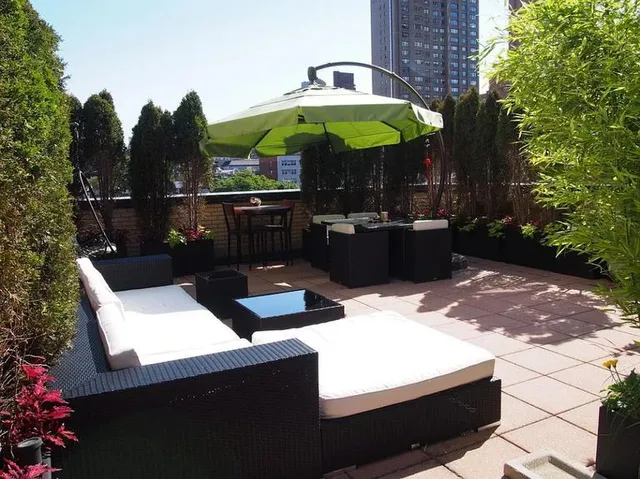 a view of a two chairs under an umbrella in patio