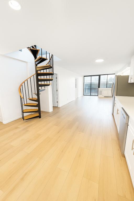507 East 80th Street, Unit PH8R Manhattan, NY 10075 - Photo 6 of 22 a view of a bedroom with furniture and wooden floor