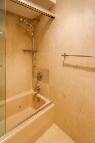 a bathroom with a shower and a bath tub
