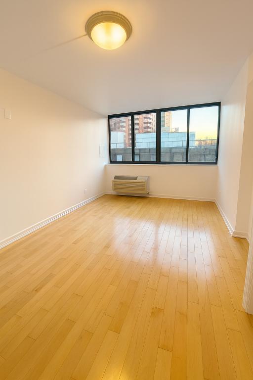 507 East 80th Street, Unit PH8R Manhattan, NY 10075 - Photo 9 of 22 an empty room with wooden floor and windows
