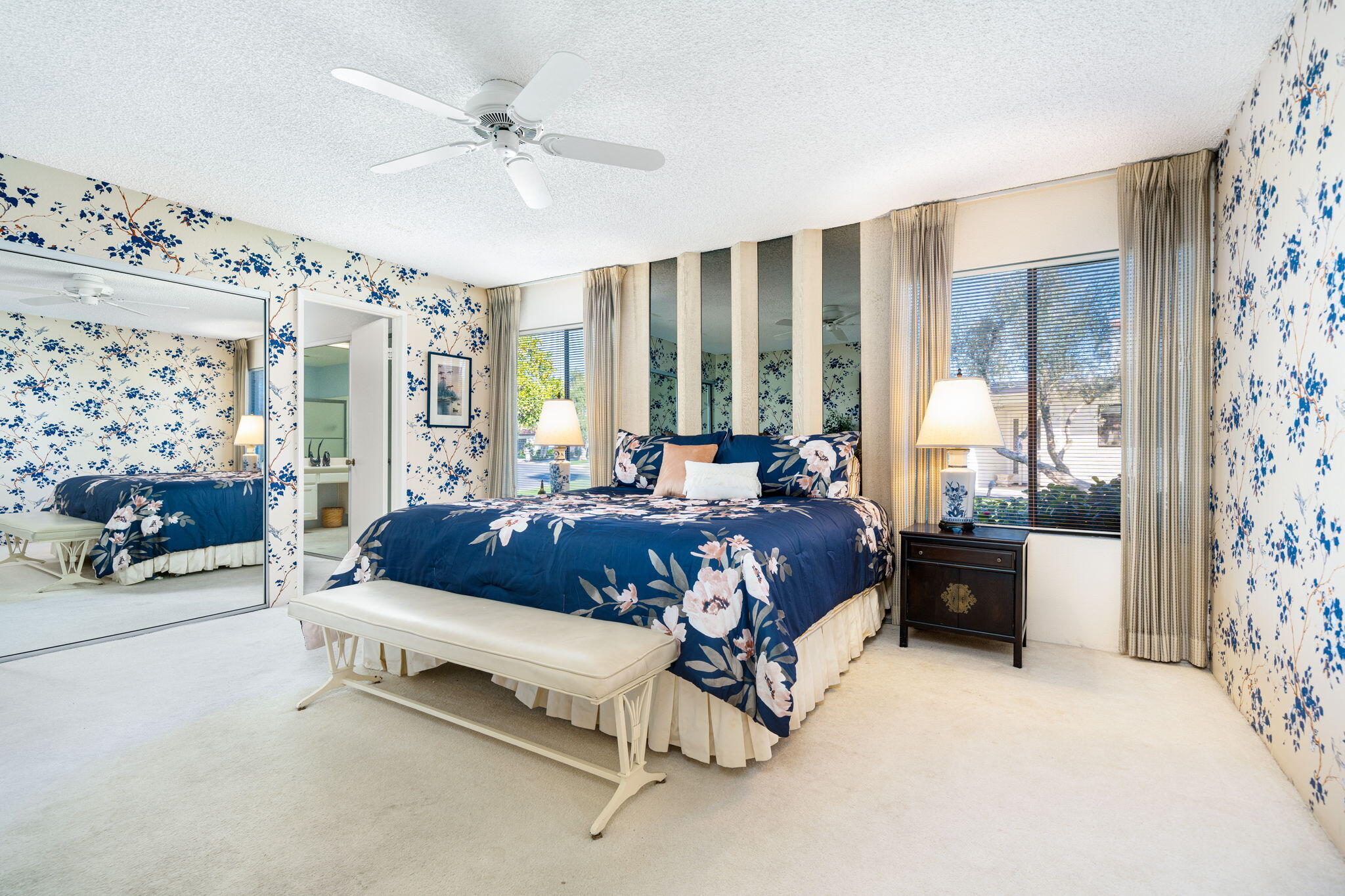 7 Leon Way Rancho Mirage, CA 92270 - Photo 22 of 45 a spacious bedroom with a bed and a chandelier