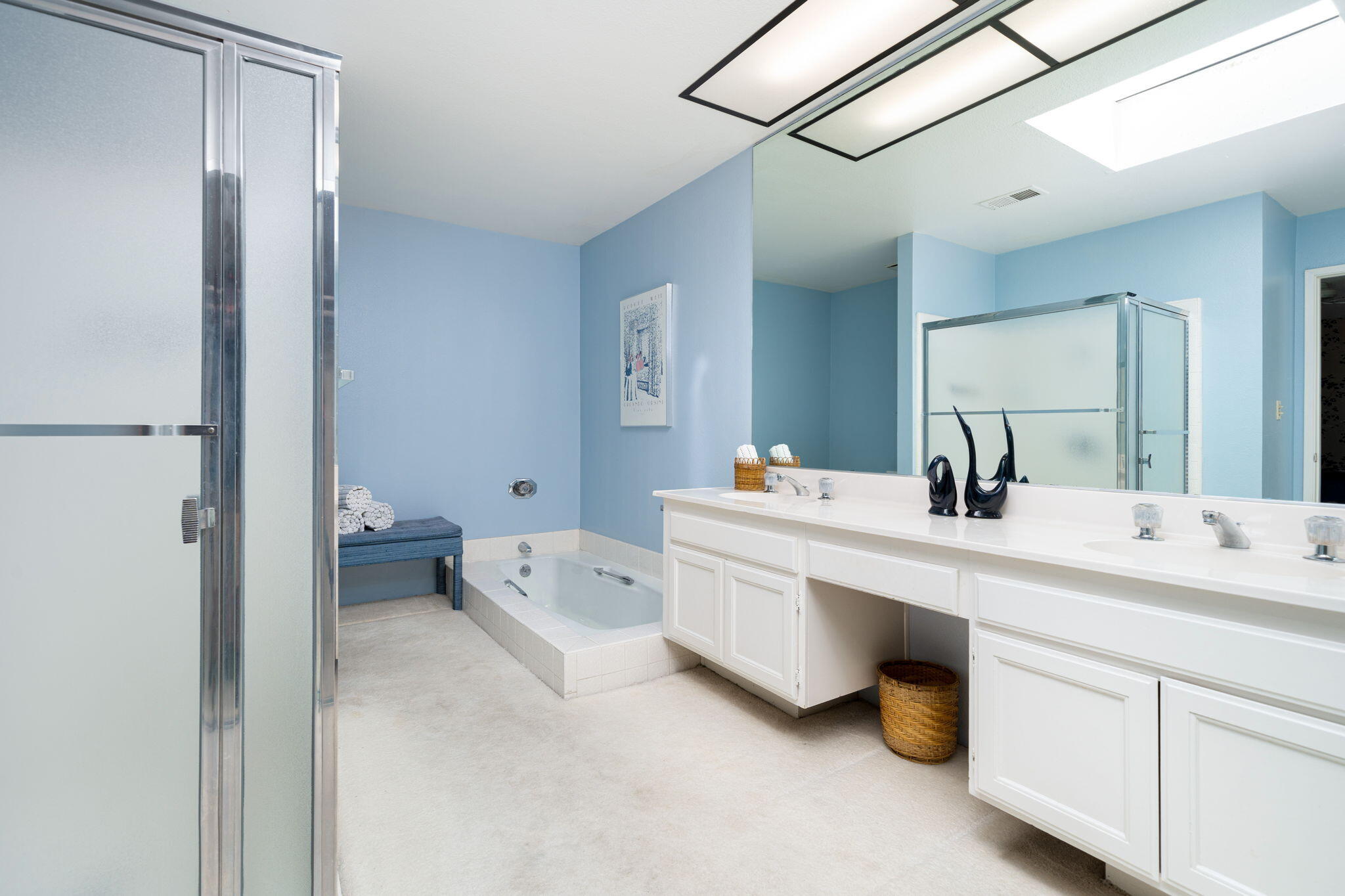 7 Leon Way Rancho Mirage, CA 92270 - Photo 24 of 45 a spacious bathroom with a double vanity sink mirror and bathtub
