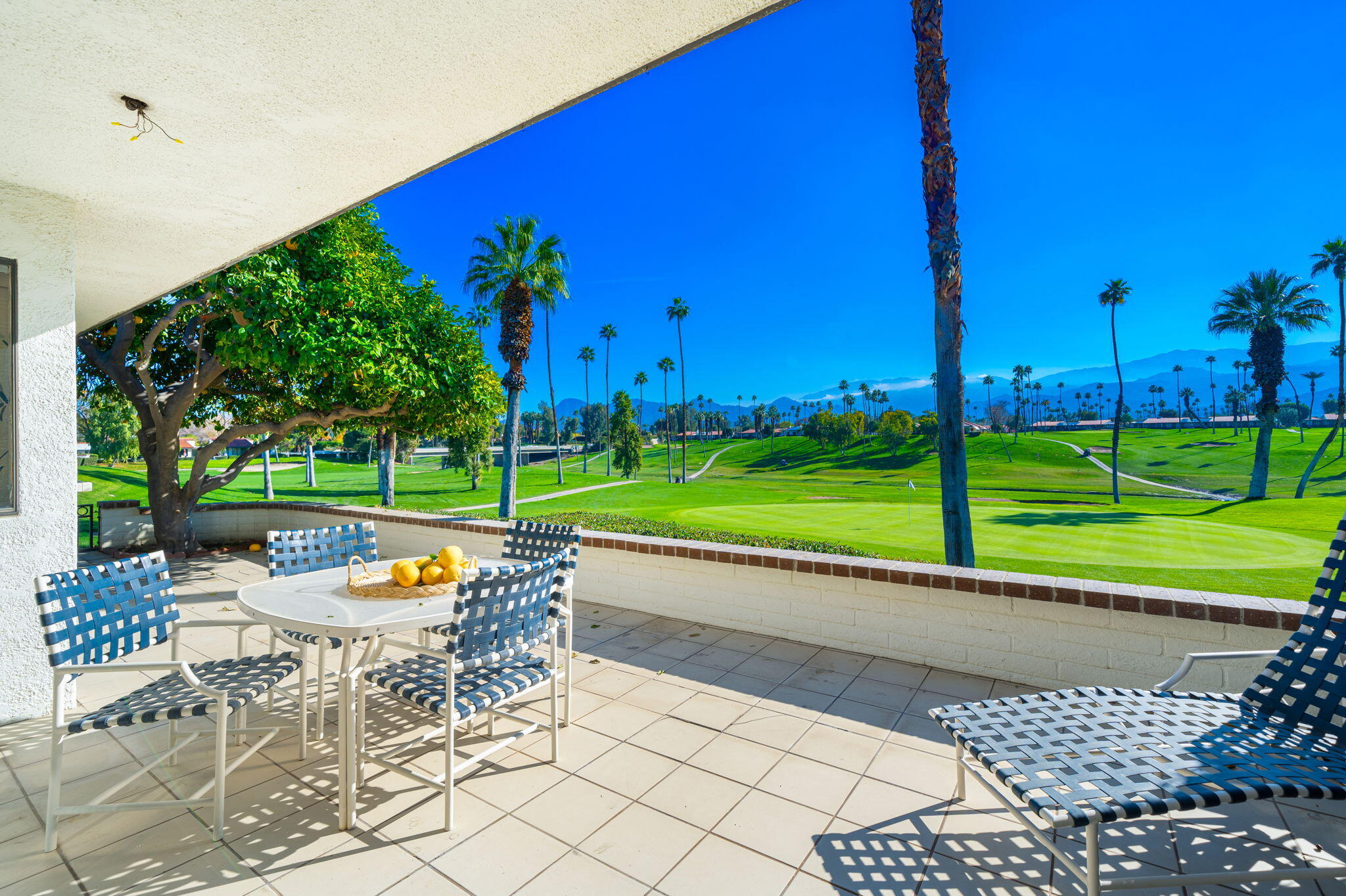7 Leon Way Rancho Mirage, CA 92270 - Photo 3 of 45 a view of a chairs and table in backyard