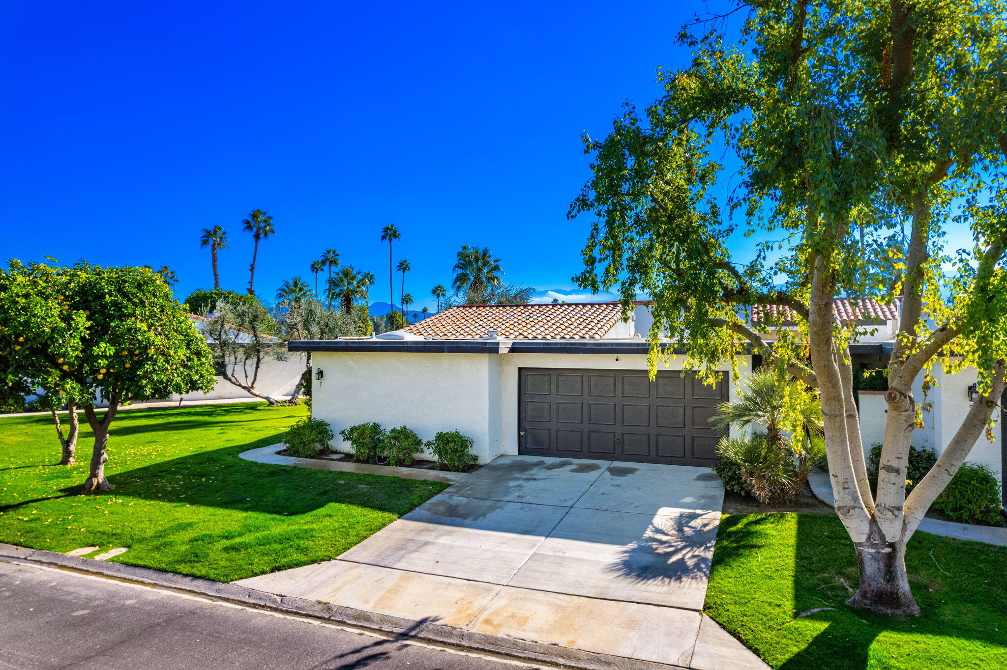 7 Leon Way Rancho Mirage, CA 92270 - Photo 34 of 45 a front view of a house with garden