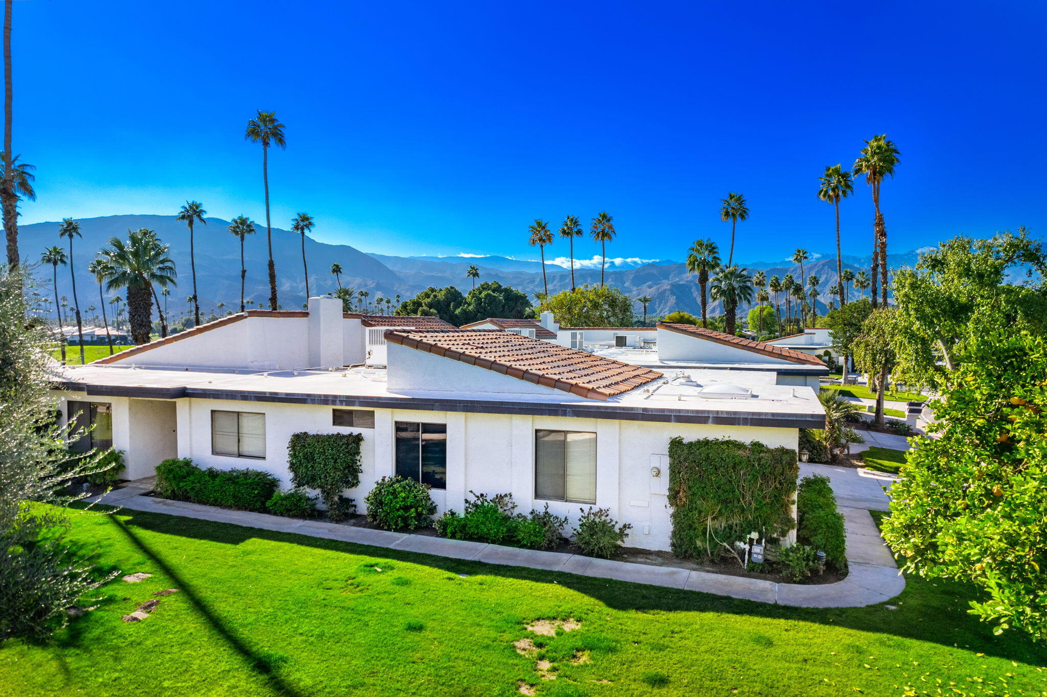 7 Leon Way Rancho Mirage, CA 92270 - Photo 35 of 45 a front view of a house with a garden