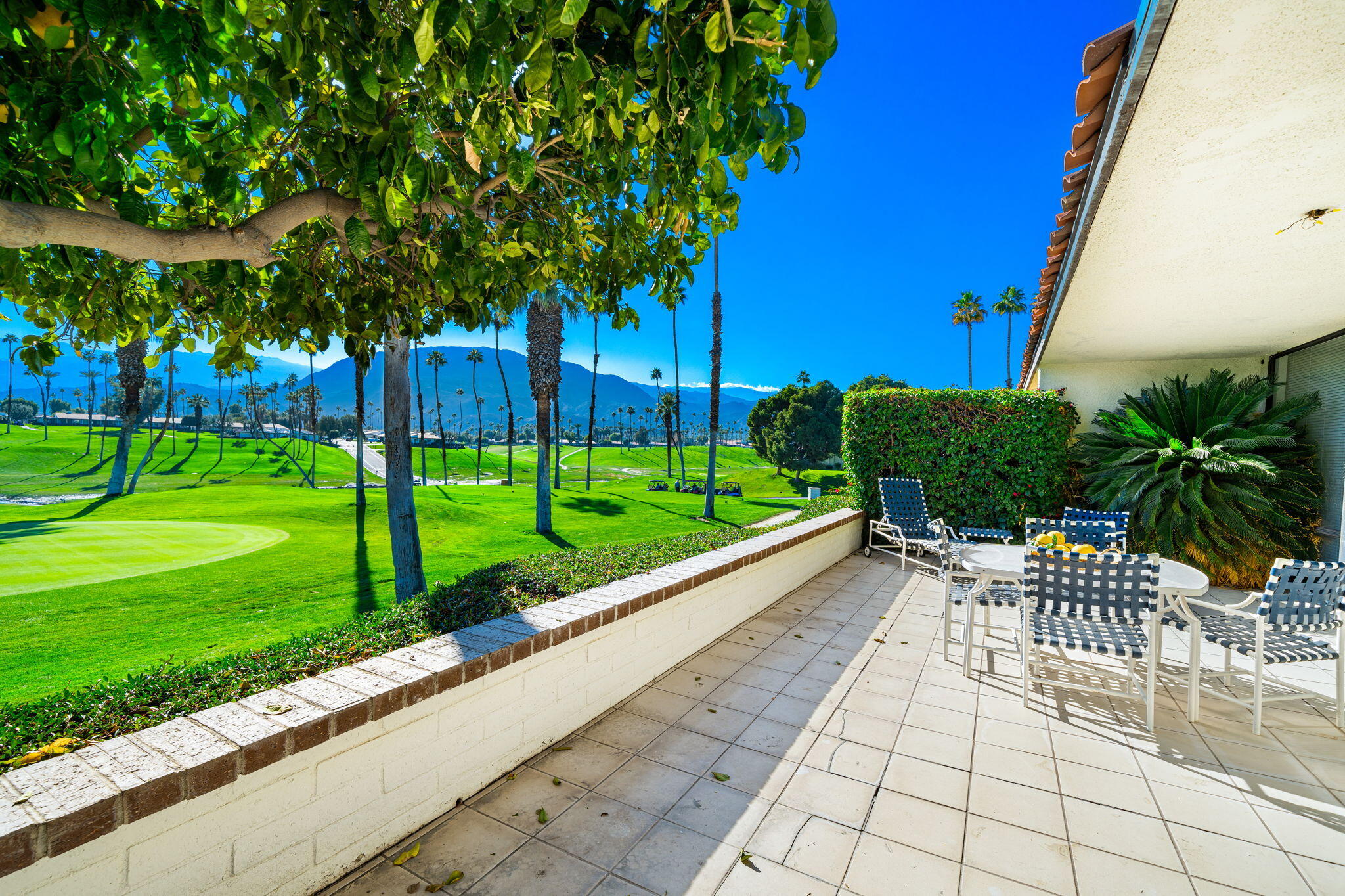 7 Leon Way Rancho Mirage, CA 92270 - Photo 4 of 45 a view of a chair and tables in the backyard of the house
