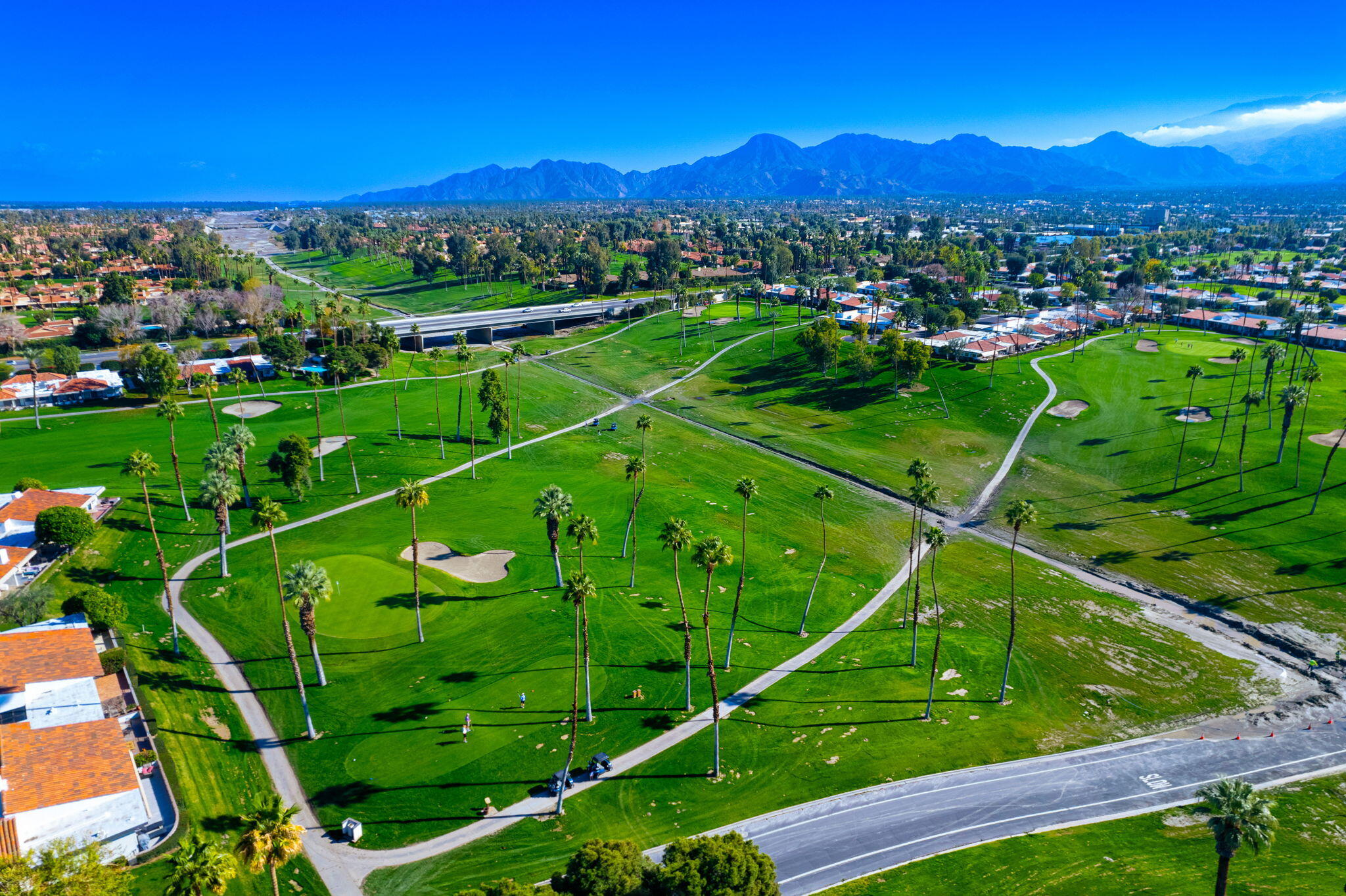 7 Leon Way Rancho Mirage, CA 92270 - Photo 41 of 45 a view of a houses with a lush green forest
