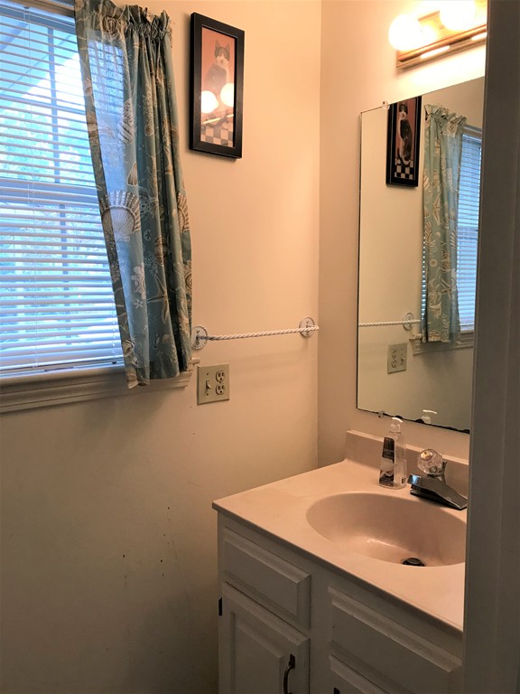 301 Ridgefield Circle, Unit B Clinton, MA 01510 - Photo 12 of 21 a bathroom with a sink and a mirror