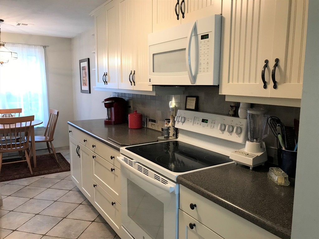301 Ridgefield Circle, Unit B Clinton, MA 01510 - Photo 3 of 21 a kitchen with white cabinets a sink and dishwasher