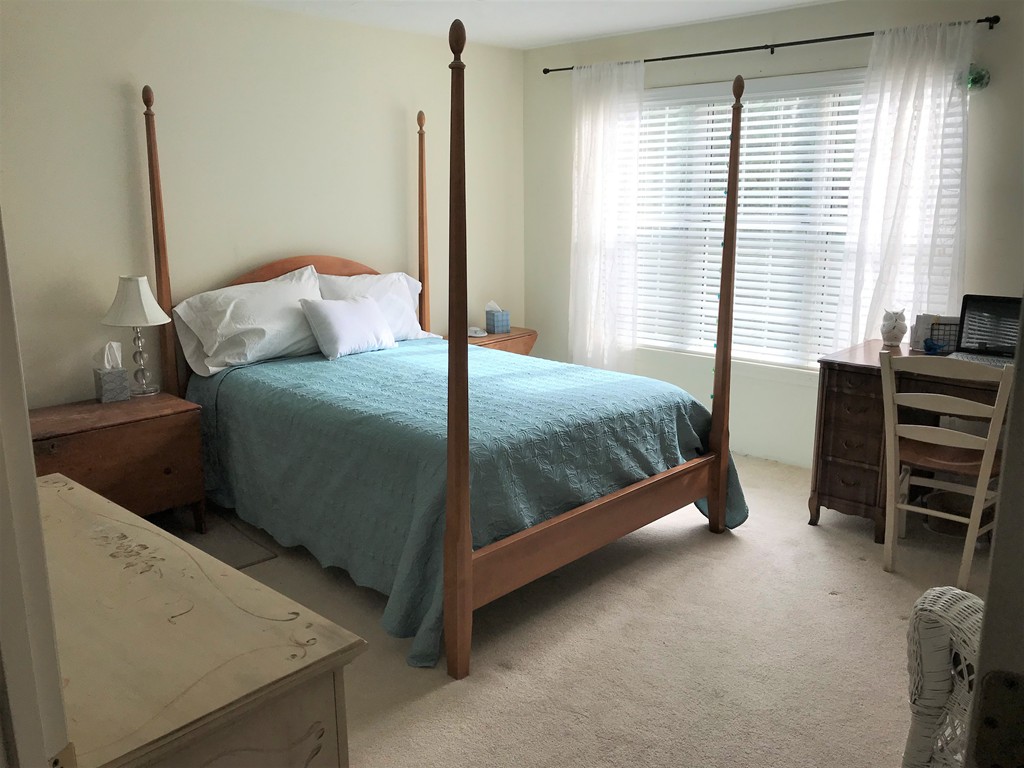 301 Ridgefield Circle, Unit B Clinton, MA 01510 - Photo 8 of 21 a bed sitting in a bedroom next to a window