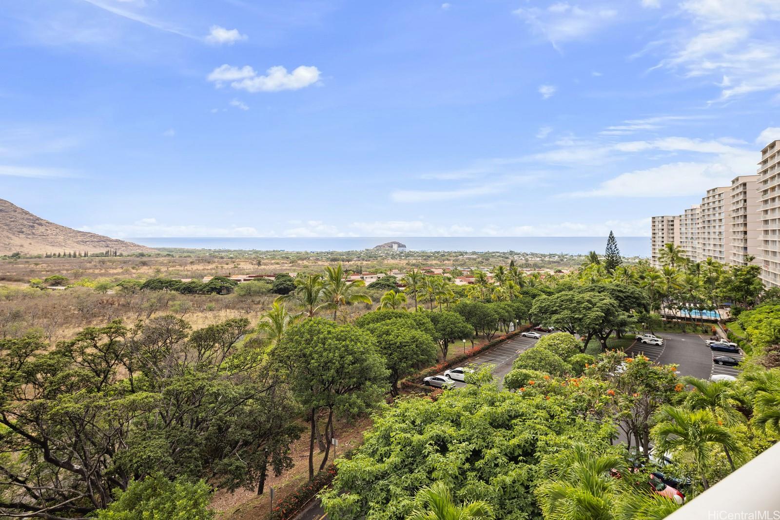 a view of a city with lush green forest