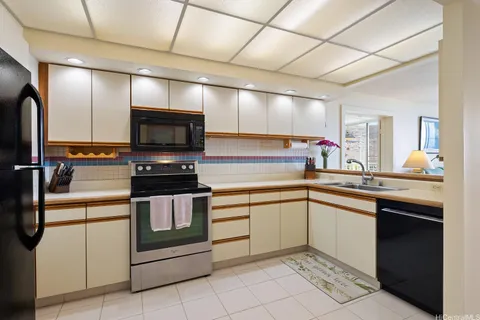 a kitchen with stainless steel appliances a stove sink and microwave