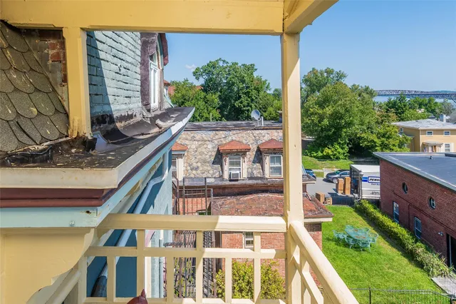 a view of a garden with plants and large trees