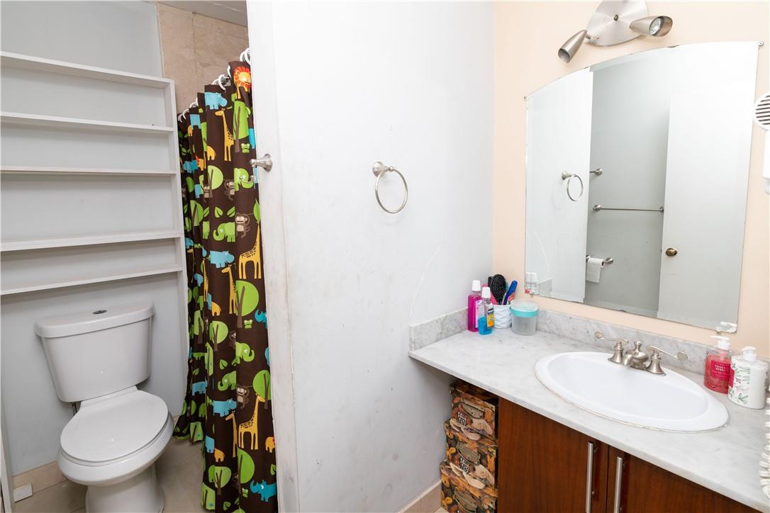 9234 Southwest 5th Street, Unit A Boca Raton, FL 33428 - Photo 12 of 20 a bathroom with a sink toilet and shower