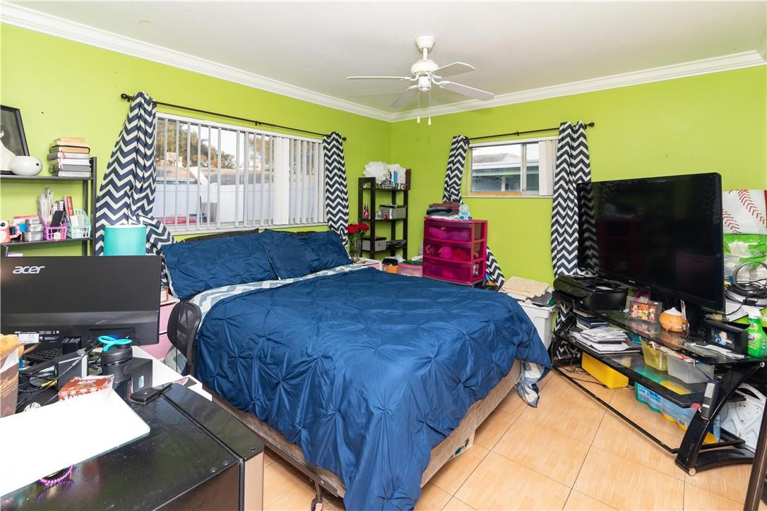 9234 Southwest 5th Street, Unit A Boca Raton, FL 33428 - Photo 13 of 20 a bed room with a bed window and a flat screen tv