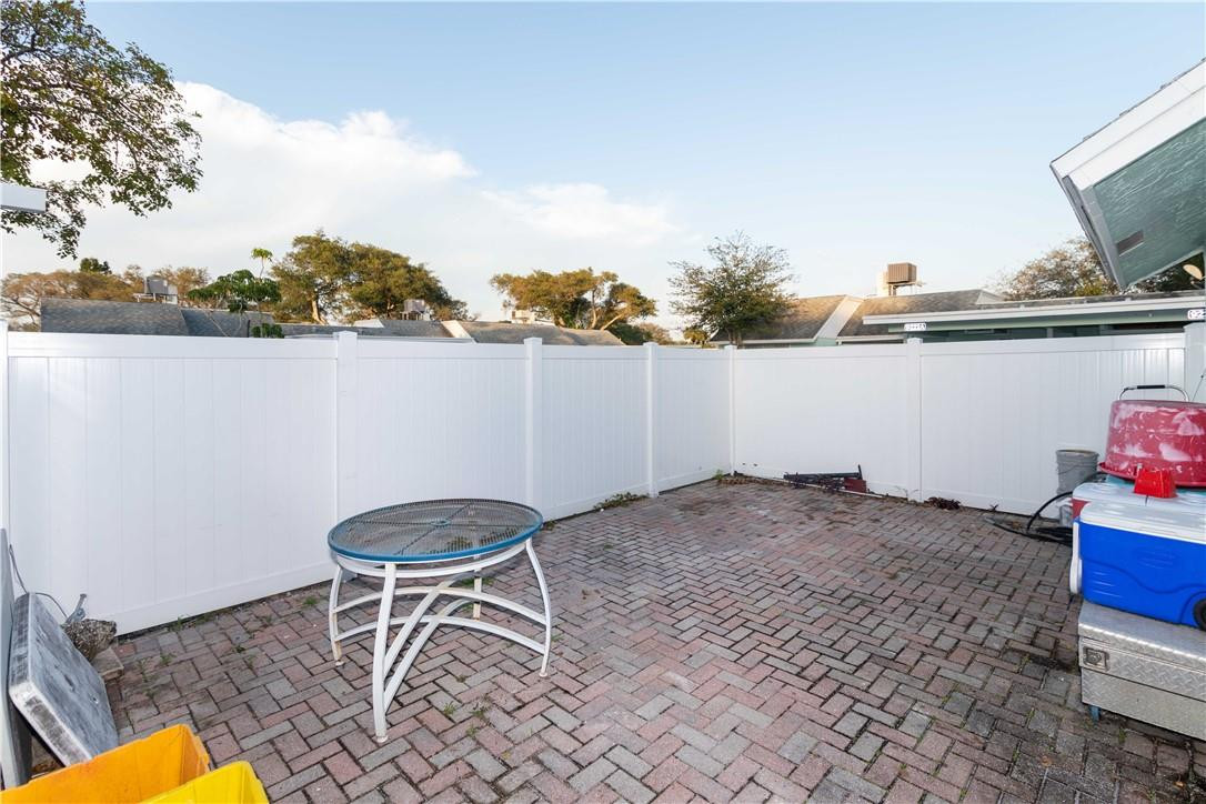 9234 Southwest 5th Street, Unit A Boca Raton, FL 33428 - Photo 17 of 20 a backyard of a house with table and chairs