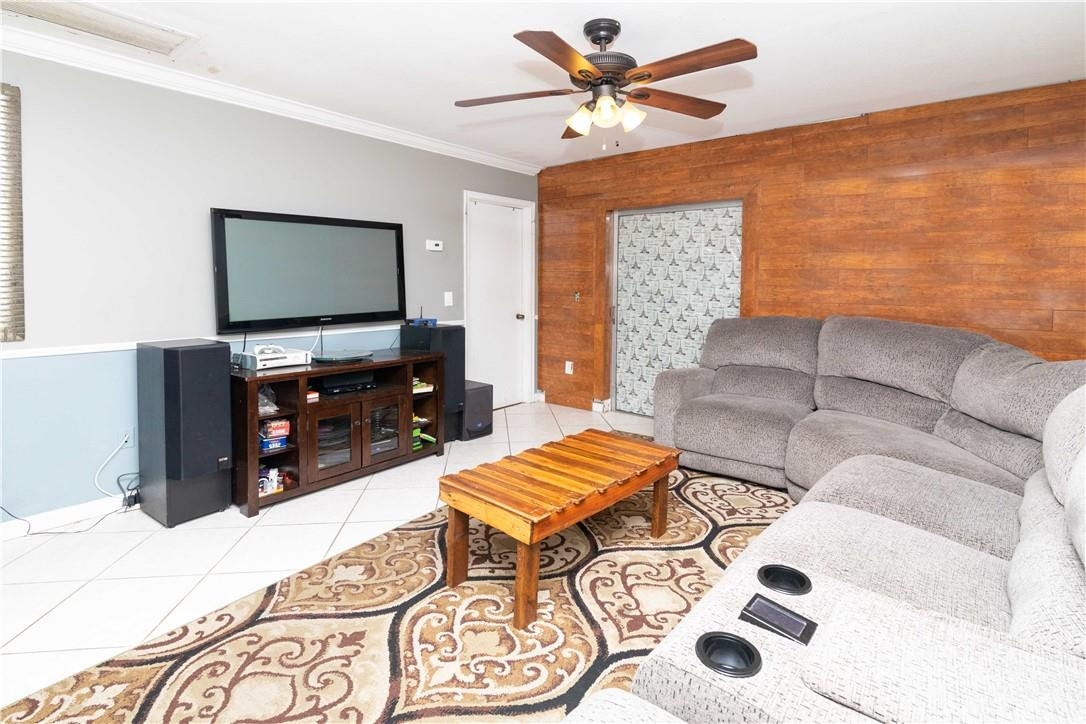 9234 Southwest 5th Street, Unit A Boca Raton, FL 33428 - Photo 3 of 20 a living room with a couch and a flat screen tv