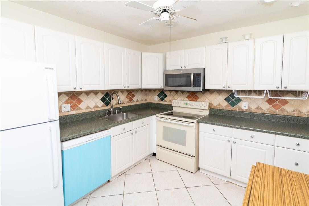 9234 Southwest 5th Street, Unit A Boca Raton, FL 33428 - Photo 7 of 20 a kitchen with granite countertop white cabinets and stainless steel appliances