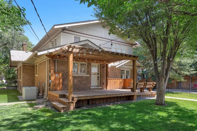 a front view of a house with a yard and seating space
