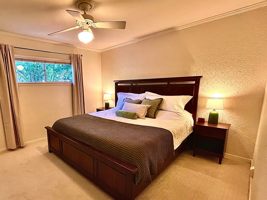 4501 Sinclair Avenue Austin, TX 78756 - Photo 15 of 21 a bedroom with a bed lamp and a large window