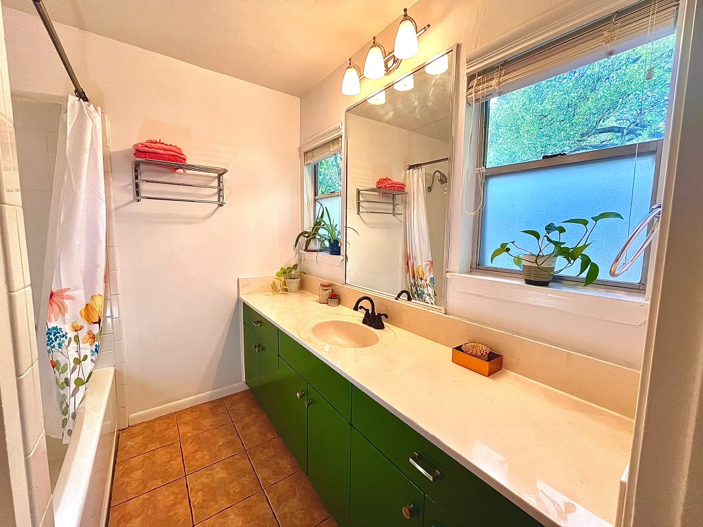 4501 Sinclair Avenue Austin, TX 78756 - Photo 16 of 21 a bathroom with a granite countertop sink and a large mirror
