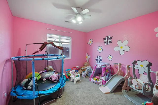 a view of a workspace with furniture and a chandelier