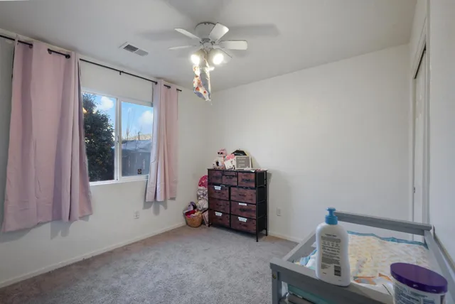 a bedroom with bed and a chandelier