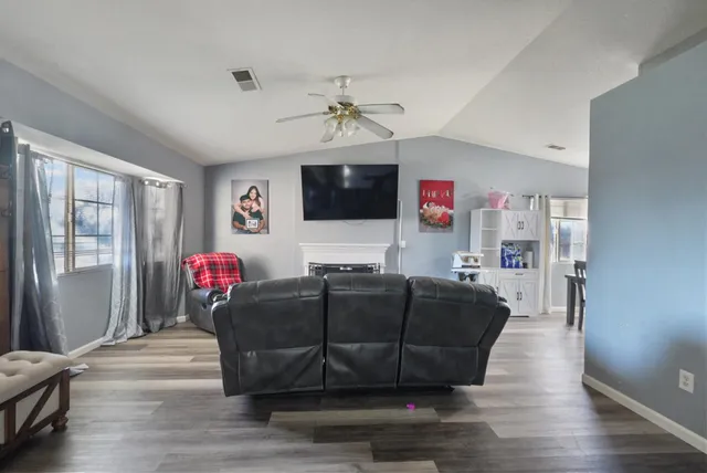 a living room with furniture and wooden floor