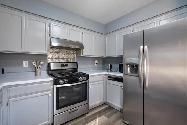 a view of a hallway and wooden floor