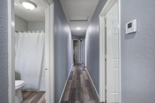a bathroom with a sink a toilet and shower curtain