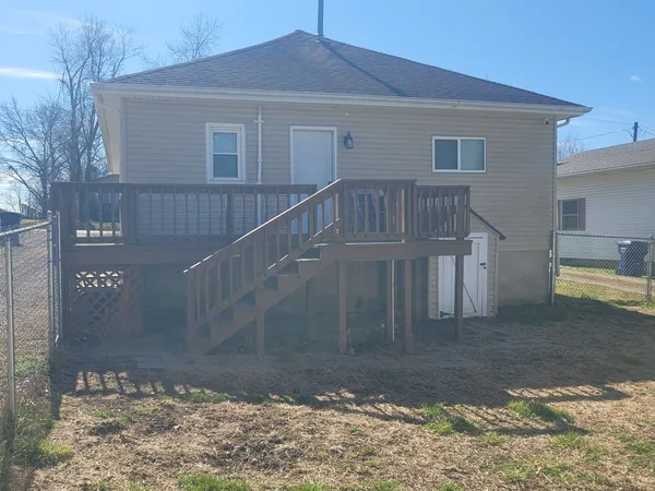 a view of a house with a small yard and sitting area