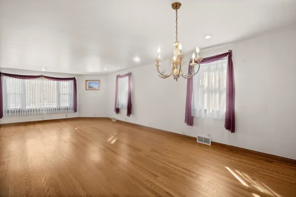 a view of a room with window wooden floor and glass door