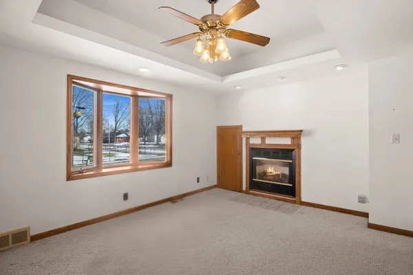 a view of a livingroom with a ceiling fan and window