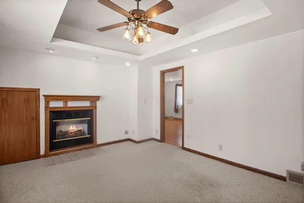 a view of an empty room with a fireplace