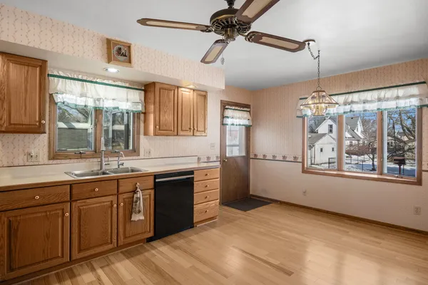 a large kitchen with a large window appliances and cabinets
