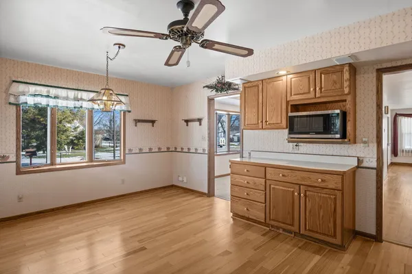 a kitchen with stainless steel appliances kitchen island granite countertop a stove a sink and a microwave