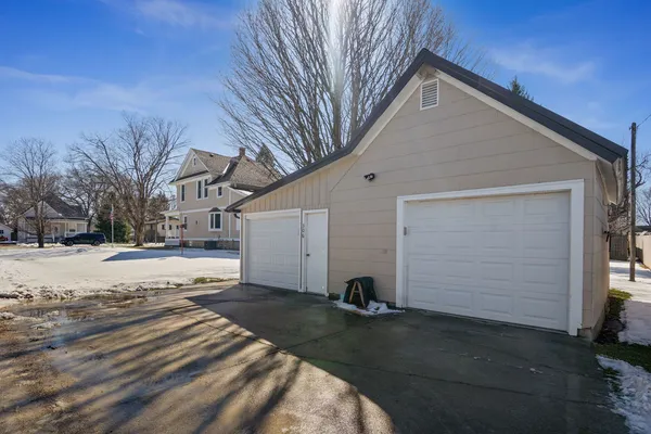 a view of a balcony with wooden floor next to a iron stairs