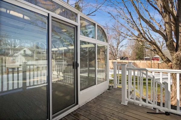 a wooden house with a large tree in front of it