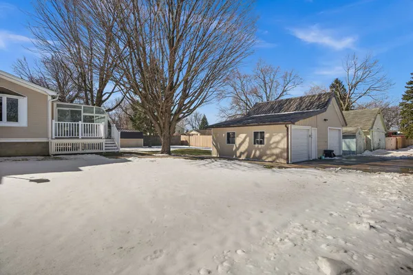 a view of a house with swimming pool and sitting area