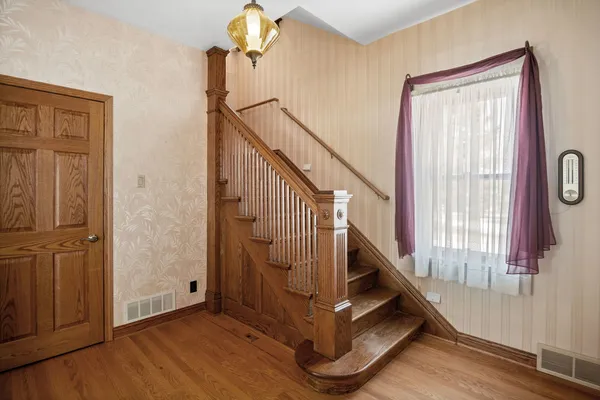 a view of entryway with wooden floor and stairs