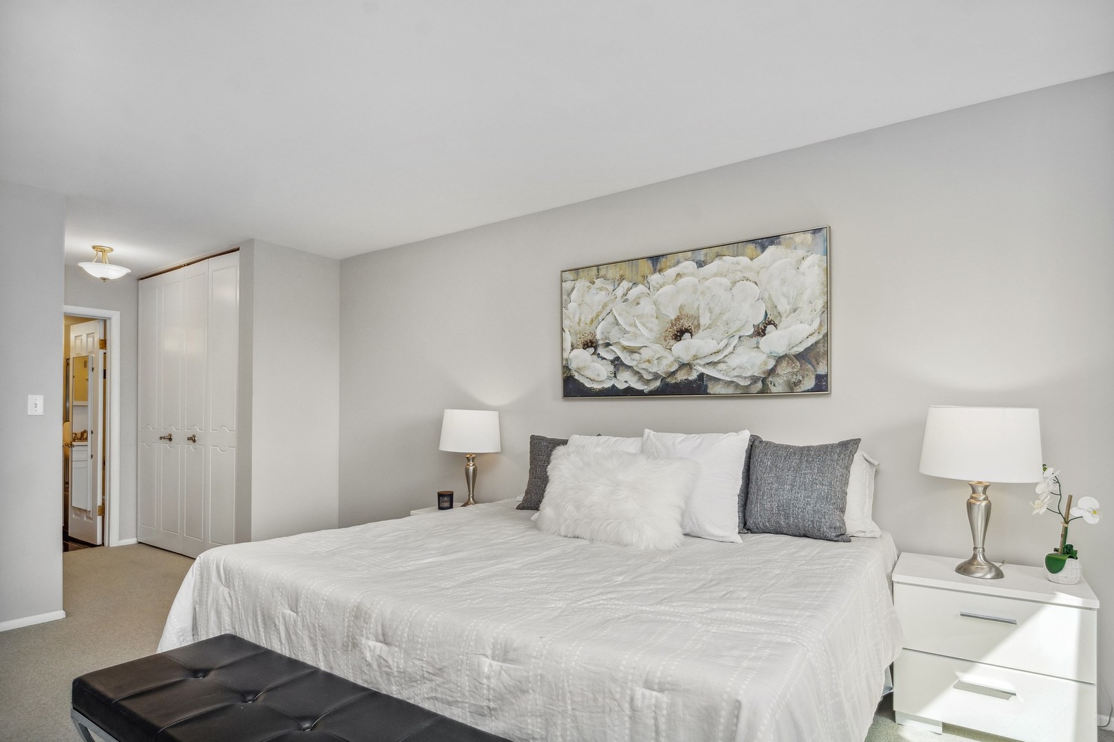 7200 North Ridge Boulevard, Unit 4E Chicago, IL 60645 - Photo 12 of 21 a bedroom with a bed and wall painting on the wall