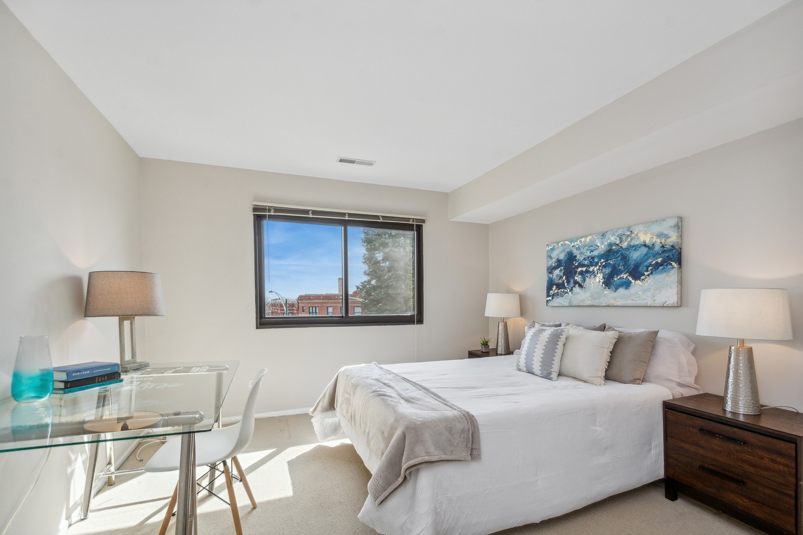 7200 North Ridge Boulevard, Unit 4E Chicago, IL 60645 - Photo 14 of 21 a bedroom with a bed and a lamp on table