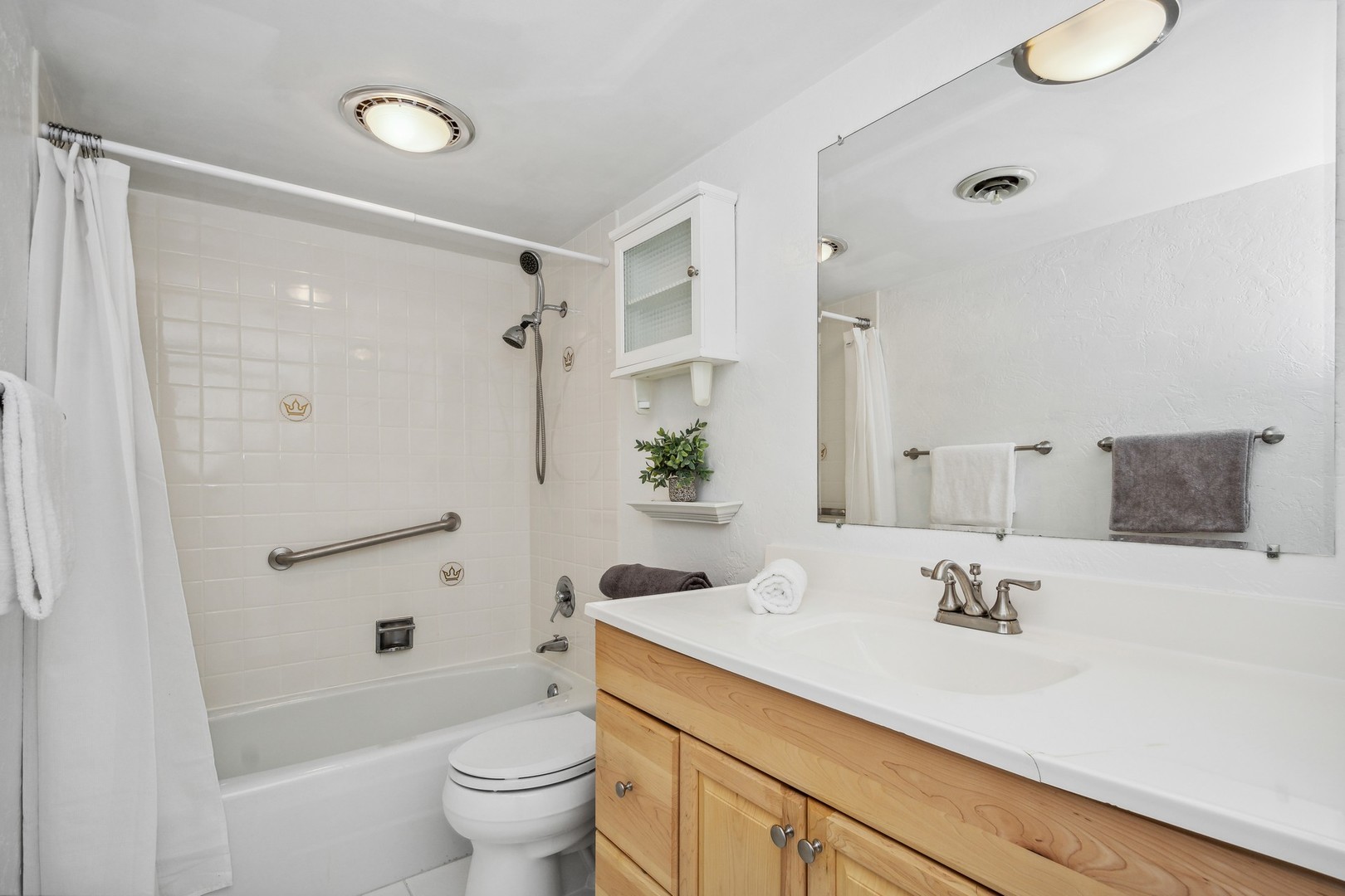 7200 North Ridge Boulevard, Unit 4E Chicago, IL 60645 - Photo 16 of 21 a bathroom with a sink a toilet and shower