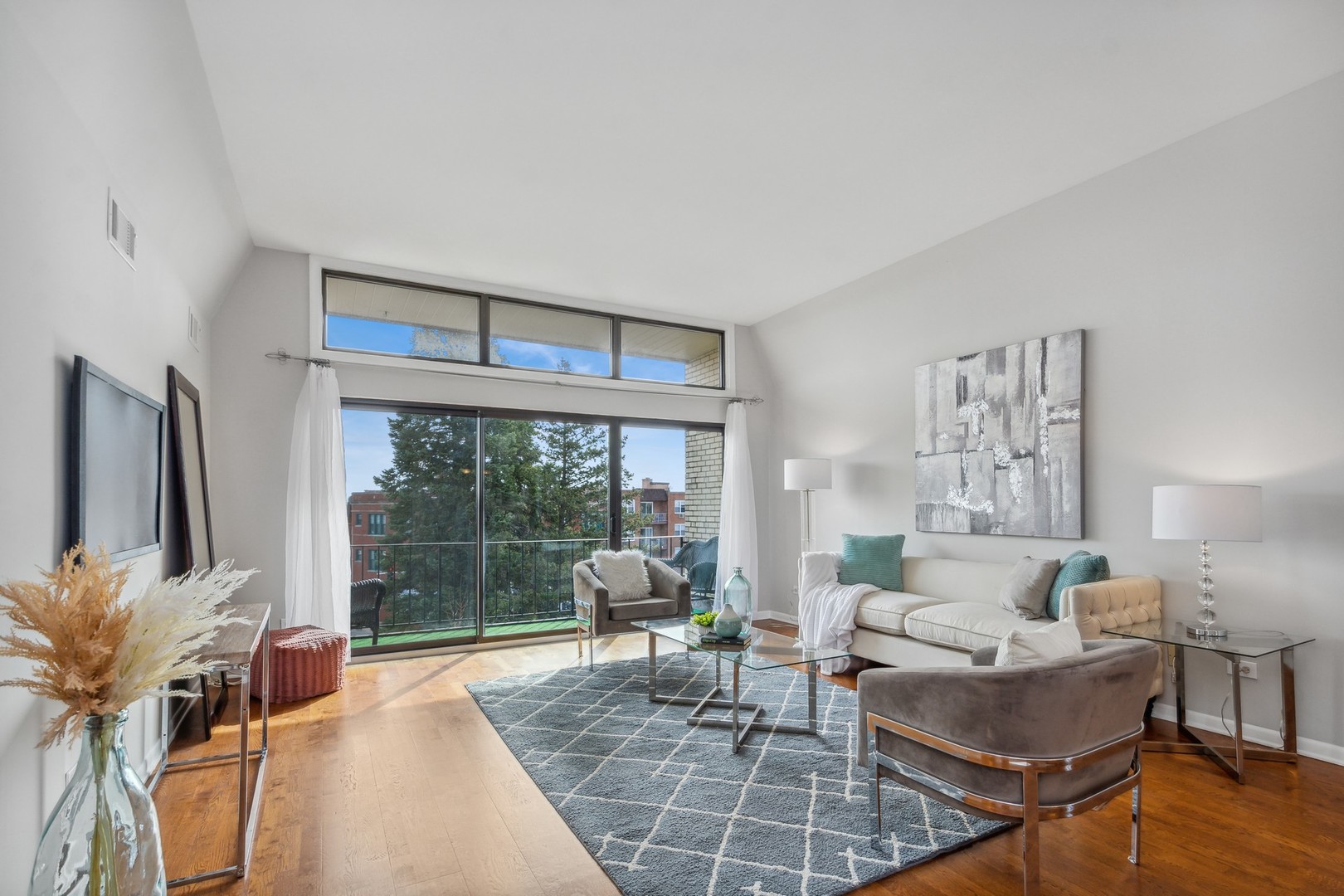 7200 North Ridge Boulevard, Unit 4E Chicago, IL 60645 - Photo 3 of 21 a living room with furniture a window and a flat screen tv