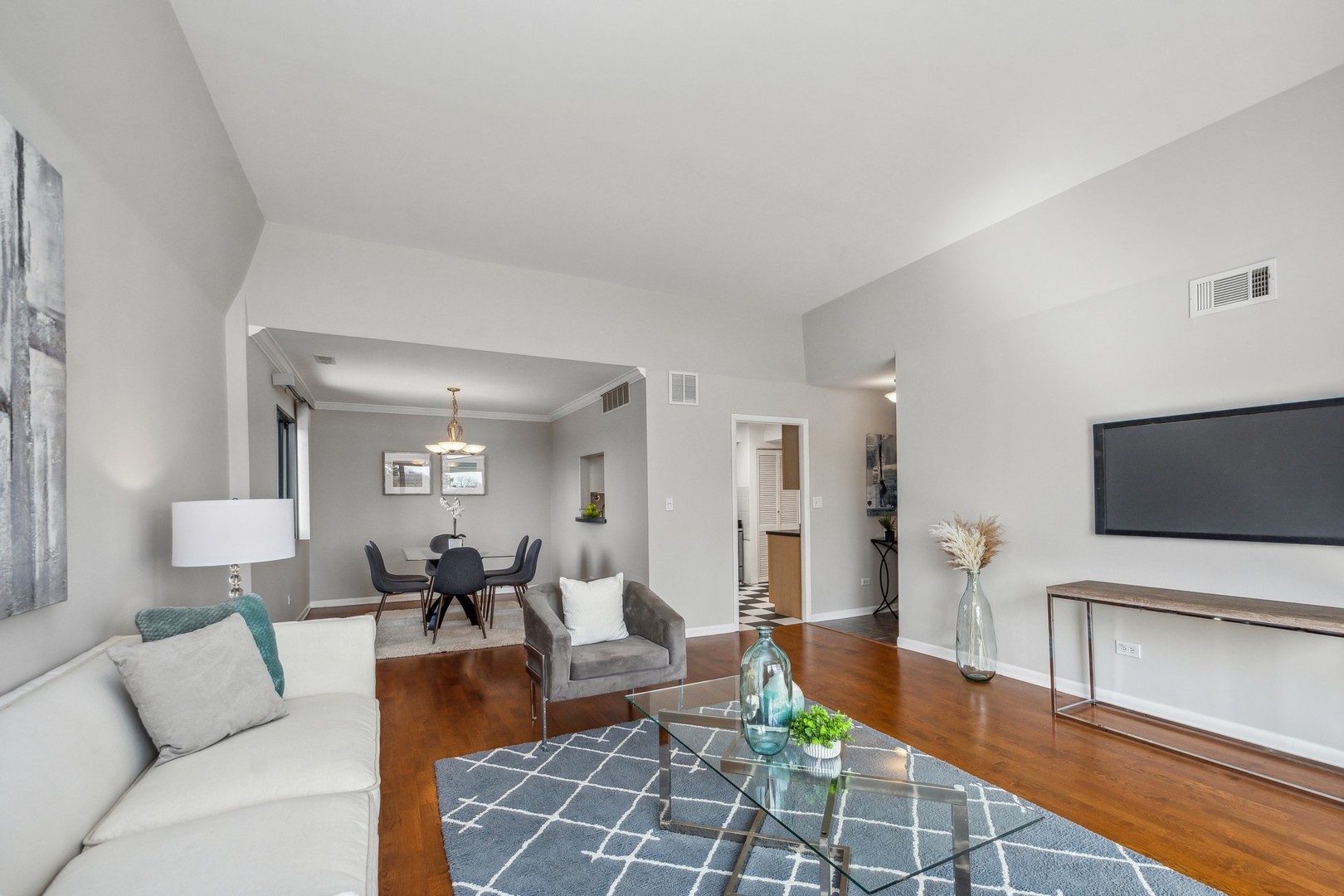 7200 North Ridge Boulevard, Unit 4E Chicago, IL 60645 - Photo 6 of 21 a living room with furniture and a flat screen tv
